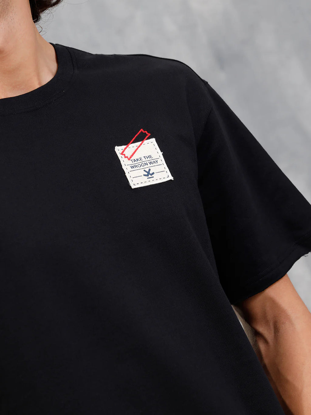 Solid Oversized T-Shirt With Printed Canvas Patch And Raw Edge Detail | Black